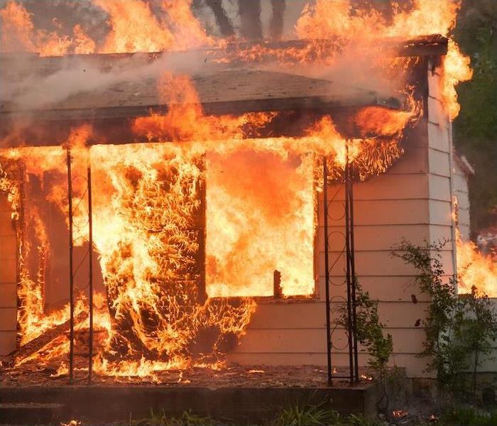  img src =”fire” alt = "a home set ablaze in a raging fire” >